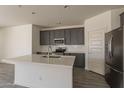 Well-equipped kitchen with quartz countertops, stainless steel appliances, and stylish cabinetry at 2205 S 241St Dr, Buckeye, AZ 85326