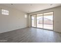 Bright living room with tile flooring and a sliding glass door leading to the backyard at 2205 S 241St Dr, Buckeye, AZ 85326