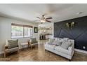 Bright living room with stylish decor, tile flooring, and a view into the adjacent kitchen at 2405 W Cordia Ln, Phoenix, AZ 85085