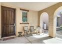 Inviting front entryway featuring neutral-colored stucco walls, and seating area with chairs at 2542 W Gaby Rd, Phoenix, AZ 85041