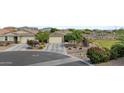 Residential street view showcasing a single-story home with desert landscaping and proximity to green space at 37103 N El Morro Trl, San Tan Valley, AZ 85140