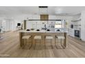 Spacious kitchen featuring island with seating, stainless appliances, and custom cabinets at 3904 S Butte Ave, Tempe, AZ 85282