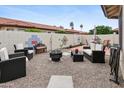 Cozy backyard featuring gravel, mature landscaping, stylish outdoor seating, and a fire pit at 542 S Higley Rd # 52, Mesa, AZ 85206