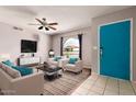 Bright living room with plush seating, ceiling fan, and modern décor at 5537 W Boca Raton Rd, Glendale, AZ 85306