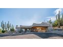 Exterior shot featuring desert landscaping, a covered drive, and a Southwestern aesthetic at 612 N Signal Butte Rd, Mesa, AZ 85207