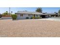 Charming single-story home with a well-manicured yard, a convenient carport, and a gravel yard at 615 E Mckellips Rd, Tempe, AZ 85288