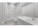 Pristine bathroom with a shower-tub combo, white double sink vanity, and chrome fixtures at 674 W Rock Needle Trl, Apache Junction, AZ 85120