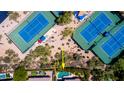 Aerial view of a community with swimming pool, tennis courts, and mature landscaping at 6855 E Amber Sun Dr, Scottsdale, AZ 85266