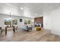 Open-plan living room featuring abundant light, wood floors, and modern contemporary decor at 7836 E Juanita Ave, Mesa, AZ 85208