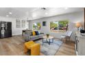 Open-concept living room boasts a sofa, stylish decor, and seamless flow for modern living at 7836 E Juanita Ave, Mesa, AZ 85208