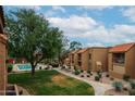 Serene view of the community showcasing lush landscaping and a refreshing pool at 8260 E Arabian Trl # 257, Scottsdale, AZ 85258