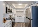 Well-lit kitchen with quartz counters, stainless steel appliances, and bright white cabinetry at 8260 E Arabian Trl # 257, Scottsdale, AZ 85258