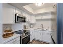 Modern kitchen featuring sleek white cabinets and stainless steel appliances at 8260 E Arabian Trl # 257, Scottsdale, AZ 85258