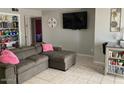 Cozy living room with a large sectional sofa and tile flooring at 849 W Duke Dr, Tempe, AZ 85283