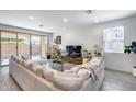 Comfortable living room with a large sectional couch and sliding glass doors to the backyard at 9916 E Texas Ave, Mesa, AZ 85212