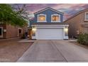 Charming two-story home featuring a large two car garage, beautiful blue siding, and a lovely tiled roof at 10831 E Azalea Ave, Mesa, AZ 85208