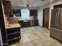 Modern kitchen with stainless steel appliances, updated cabinets, tile floors and large window at 12607 N 23Rd St, Phoenix, AZ 85022