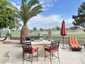 Outdoor kitchen and grill area with a built-in grill, seating, and landscaping at 13458 W Coronado Rd, Goodyear, AZ 85395