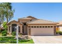 Attractive single-story home featuring a tile roof, stone accents, and a well-maintained front yard at 1424 W Mead Dr, Chandler, AZ 85248