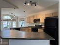 Well-lit kitchen with black appliances, light wood cabinetry, and a view of the neighborhood at 1424 W Mead Dr, Chandler, AZ 85248