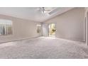 Bright and airy living room with vaulted ceilings and a sliding glass door to the backyard at 1424 W Mead Dr, Chandler, AZ 85248