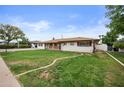 Charming single-story home with a well-maintained lawn, landscaping and a welcoming facade at 1431 E 1St St, Mesa, AZ 85203