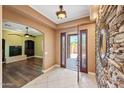Bright foyer features tile flooring, stone accent wall, and an open view into the living space at 1435 E Rancho Dr, Phoenix, AZ 85014