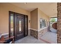 Elegant front door with decorative glass panels, stone accents, and a covered porch at 1435 E Rancho Dr, Phoenix, AZ 85014