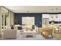 Stylish living room featuring an open concept design, modern furniture, and a large window for ample sunlight at 15797 W Kendall St, Goodyear, AZ 85338