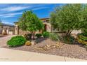 Charming home exterior with desert landscaping and mature shade trees at 1804 E Sattoo Way, Queen Creek, AZ 85140
