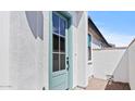 Stylish turquoise front door in a bright white stucco home at 20308 W Roma Ave, Buckeye, AZ 85396