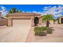 Attractive house with a two-car garage, desert landscaping, and a stone facade at 20740 N 62Nd Ave, Glendale, AZ 85308