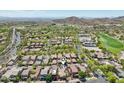A home pinpoints the location within a lovely, well-maintained neighborhood surrounded by a golf course and desert landscape at 21155 W Green St, Buckeye, AZ 85396