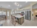 Bright kitchen with stainless steel appliances, a center island, and tile flooring at 2343 E Kempton Rd, Chandler, AZ 85225