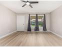 Spacious bedroom with modern fan, neutral colors, and a bright window at 2502 N 22Nd Dr, Phoenix, AZ 85009