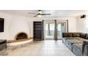 Inviting living room features a unique fireplace, tile flooring, and access to the outdoor patio at 2609 N Pleasant Dr, Chandler, AZ 85225
