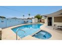 Beautiful backyard with a private pool, jacuzzi, and a cozy seating area, perfect for outdoor relaxation at 2609 N Pleasant Dr, Chandler, AZ 85225