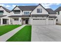 Charming new construction home with a manicured lawn, long driveway, and a three car garage at 26643 S 169Th Pl, Queen Creek, AZ 85142