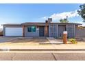 Charming single-story home with grey exterior, walkway, and well-maintained landscaping at 3021 E Larkspur Dr, Phoenix, AZ 85032