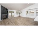 Open living room featuring a sleek fireplace and floor to ceiling windows with a view to the backyard at 3022 E Emile Zola Ave, Phoenix, AZ 85032