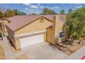 Inviting tan home with a two-car garage, a well-maintained yard, and a tile roof at 3252 E Maldonado Dr, Phoenix, AZ 85042