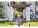 Charming gated courtyard entrance with covered pergola and vibrant floral accents on either side at 3637 E Monterosa St # 3, Phoenix, AZ 85018