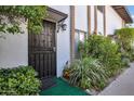 Charming front entryway featuring a secure door, decorative lantern, and manicured landscaping at 3637 E Monterosa St # 3, Phoenix, AZ 85018