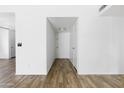 Hallway featuring wood floors, white walls, and neutral colored doors leading to other rooms in the home at 4133 E Pleasant Ln, Phoenix, AZ 85042