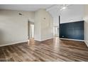 Spacious open-concept living room with wood-look floors and modern paint scheme at 5127 W Willow Ave, Glendale, AZ 85304