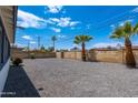 Large backyard space, featuring a gravel yard, block wall, and mature palm trees at 6316 N 23Rd Ave, Phoenix, AZ 85015