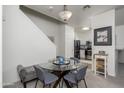Cozy dining area adjacent to kitchen, with a glass table and stairway at 7028 W Lincoln St, Peoria, AZ 85345