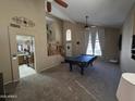 Spacious living room with stairs, large windows, open floor plan, and ceiling fan at 7240 W Los Gatos Dr, Glendale, AZ 85310