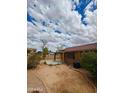 Spacious backyard with a covered patio, offering potential for outdoor entertaining and relaxation, and desert landscaping at 7310 W Pioneer St, Phoenix, AZ 85043
