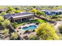 Aerial view of a single-Gathering home showcasing a stunning pool, lush landscaping, and a well-maintained backyard at 7848 E Parkview Ln, Scottsdale, AZ 85255